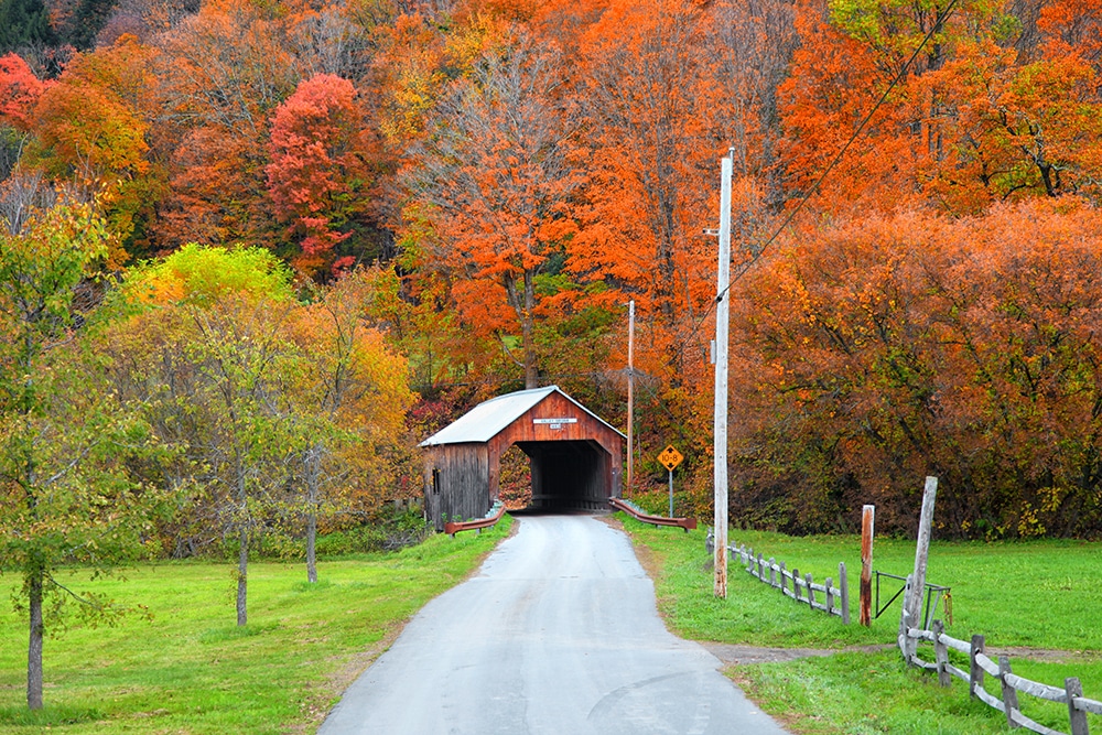 View of weathered covered bridge during the fall foliage