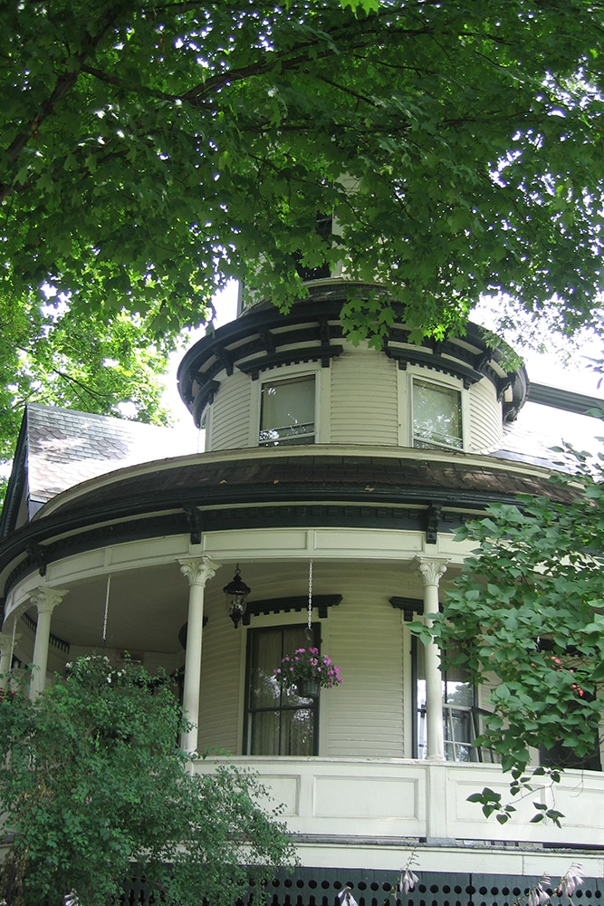 outside view of round porch and tower in the spring before new paint