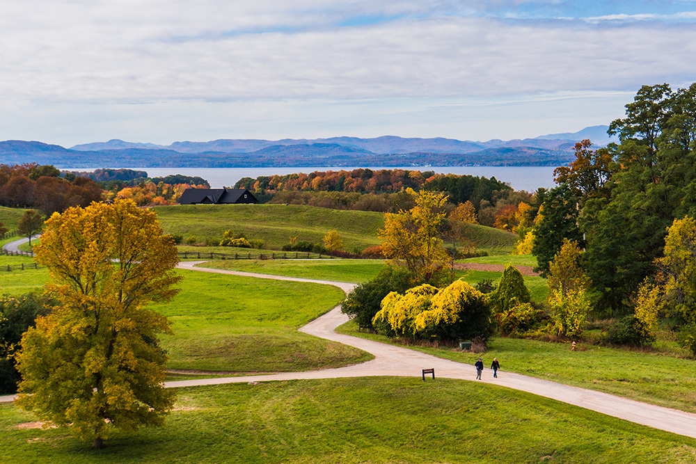 View of a park in Shelburne during the fall with Lake Champlain and the Adirondacks in the background